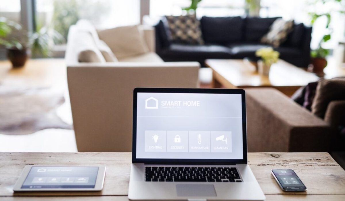 A laptop, tablet and telephone with smart home control system.